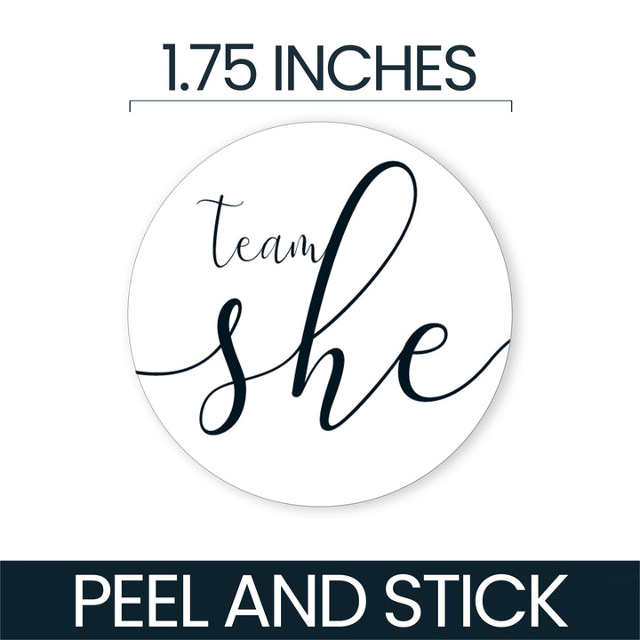A round white peel-and-stick sticker with the phrase 'team she' in dark navy script, shown with text indicating 1.75 inches and 'PEEL AND STICK' on a white background.