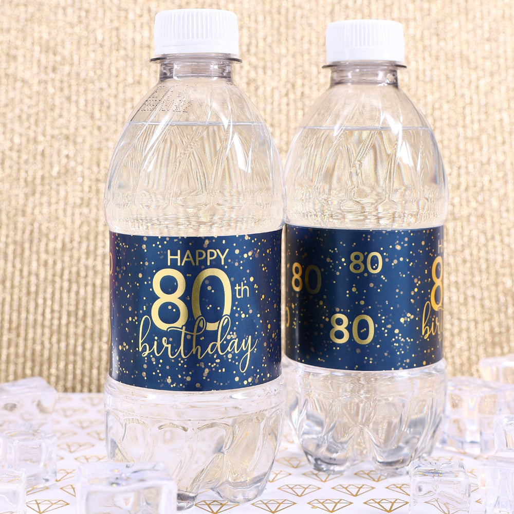 A close-up view of a navy blue water bottle label with gold lettering that reads "Happy 80th Birthday" and features a sleek, modern design