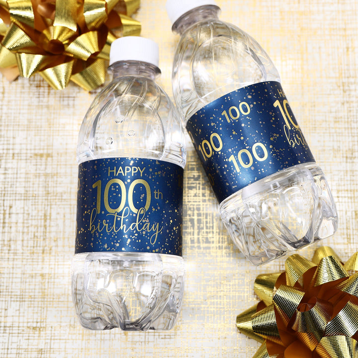 A group of water bottles with elegant navy blue and gold labels that are customized for an 100th birthday celebration, perfect for adding a personalized touch to any party