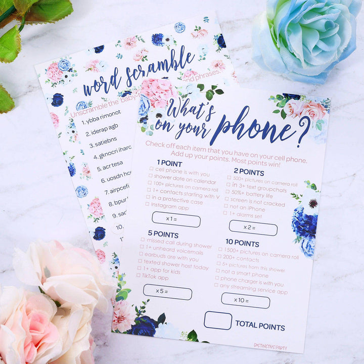 Closeup of 2 gender reveal games featuring navy blue and blush pink floral designs used as table decorations